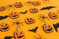 Happy Halloween. Modern pumpkins jack o lantern, spiders and bats layout on orange background. Halloween decorations on yellow Royalty Free Stock Photo