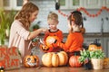 Happy Halloween! mother treats children with candy at home Royalty Free Stock Photo