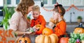 Happy Halloween! mother treats children with candy at home Royalty Free Stock Photo