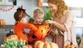 Happy Halloween! mother treats children with candy at home Royalty Free Stock Photo