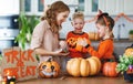 Happy Halloween! mother treats children with candy at home Royalty Free Stock Photo