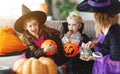 Happy Halloween! mother treats children with candy at home Royalty Free Stock Photo