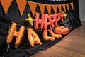 Happy Halloween orange balloon letters are prepared on the 2nd floor for hang on to the terrace with pumkin flag and black cloth