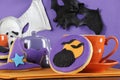 Happy Halloween party trick or treat purple and orange cookies with pumpkin and flying bats decorations