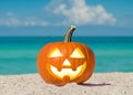 Happy Halloween. Pumpkin Jack-o\'-lantern on the beach. Jack o lantern for Halloween party. Autumn season. Blue ocean Royalty Free Stock Photo