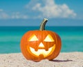Happy Halloween. Pumpkin Jack-o\'-lantern on the beach. Jack o lantern for Halloween party. Autumn season. Blue ocean Royalty Free Stock Photo