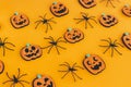 Happy Halloween. Pumpkins jack o lantern and spiders on orange background. Halloween decorations layout on yellow paper. Halloween