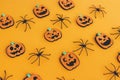 Happy Halloween. Pumpkins jack o lantern and spiders on orange background. Halloween decorations layout on yellow paper. Halloween