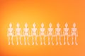 Happy Halloween row of dancing skeletons on orange background Royalty Free Stock Photo