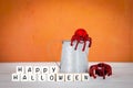 Happy Halloween sign with black and red spider on metal pot over orange background Royalty Free Stock Photo