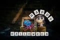 Happy Halloween sign with Cute little doctor wooden doll with blue yarn spider in treasure box over abstract old brick wall textur