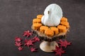 Happy Halloween, small pumpkin cakes, orange ceramic pumpkin on a wooden cake stand, plastic skeleton