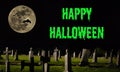 Happy Halloween - spooky graveyard with a large moon & bat silhouettes Royalty Free Stock Photo