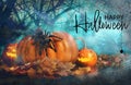 Happy Halloween. Spooky Jack O`Lantern pumpkins and creepy spider surrounded by mystical fog in night Royalty Free Stock Photo