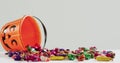 Happy halloween text banner against halloween candies fallen from pumpkin shaped bucket Royalty Free Stock Photo