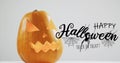 Happy halloween text banner with spider icon over halloween pumpkin against grey background Royalty Free Stock Photo