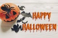 Happy halloween text flat lay. jack lantern pumpkin with witch g Royalty Free Stock Photo