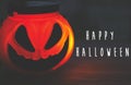 Happy Halloween text, greeting card. Spooky atmospheric jack o lantern face glowing pumpkin in dark. Trick or treat. Halloween Royalty Free Stock Photo