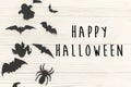 Happy Halloween text sign, flat lay. Black paper bats, spiders,