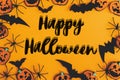 Happy Halloween text sign on modern pumpkins, jack o lanterns, spiders, bats frame flat lay on orange background. Season`s Royalty Free Stock Photo