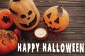 Happy Halloween text sign on pumpkins, jack-o-lantern, witch cauldron,bats, spider, candle,ghost, autumn leaves on dark Royalty Free Stock Photo