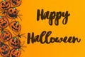 Happy Halloween text sign on pumpkins jack o lanterns, spiders border flat lay on orange background. Season`s greeting card. Royalty Free Stock Photo