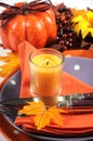 Happy Halloween or Thanksgiving party table place setting closeup.