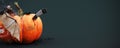 Happy Halloween. Trick or treat. Pumpkin with Bat and carving knife on dark green background with copy space.