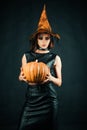 Happy Halloween witch with pumpkin. Witch magic. Sexy girl in Halloween costume. Secrets of magic. Royalty Free Stock Photo