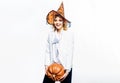 Happy Halloween witch with pumpkin. Smiling Halloween party girl in witch hat with big pumpkin. Happy Halloween Weekends Royalty Free Stock Photo