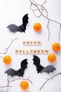 Happy Halloween wooden blocks, black paper bats and pumpkins on white background Royalty Free Stock Photo