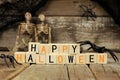 Happy Halloween wooden blocks with decor over old wood background