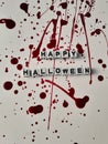 Happy Halloween words on a blood splattered white background for Halloween