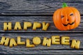 Happy Halloween words decoration with jack lantern pumpkin on wooden background Royalty Free Stock Photo