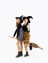 Happy Halloween, young asian women in witch hat and costume holding witch broom posing on white background Royalty Free Stock Photo