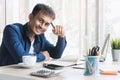 Happy handsome asian business entrepreneur smiling and working on the desk in his home. Successful young businessman in e commerce Royalty Free Stock Photo