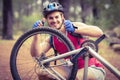 Happy handsome biker repairing bike showing thumbs up Royalty Free Stock Photo