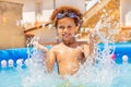 Cute curly boy splash water in small swimming pool Royalty Free Stock Photo