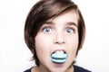 Happy handsome boy eating the macaron on white background Royalty Free Stock Photo