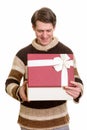 Happy handsome Caucasian man opening gift box ready for Valentin Royalty Free Stock Photo