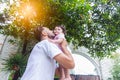 Happy handsome father kissing adorable little baby daughter with happiness and smile face. Single dad embrace and lifting his Royalty Free Stock Photo