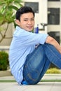 Happy Handsome Filipino Student With Books Sitting