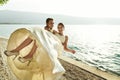 Happy handsome groom holding bride in his arms on beach at sunset Royalty Free Stock Photo