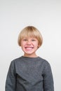 Happy handsome little boy posing in the studio. Royalty Free Stock Photo