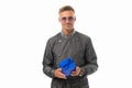 Happy handsome man in casual trenchcoat hold blue present box isolated on white, gift