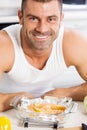 Happy handsome man cooking in kitchen at home. Royalty Free Stock Photo