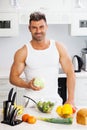 Happy handsome man cooking in kitchen at home. Royalty Free Stock Photo