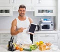 Happy handsome man cooking in kitchen at home. Royalty Free Stock Photo