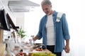 Happy handsome man cooking in kitchen at home Royalty Free Stock Photo