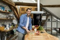 Happy handsome man cooking in kitchen at home Royalty Free Stock Photo